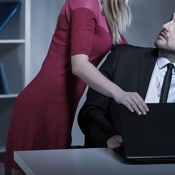 Woman leaning over male coworker